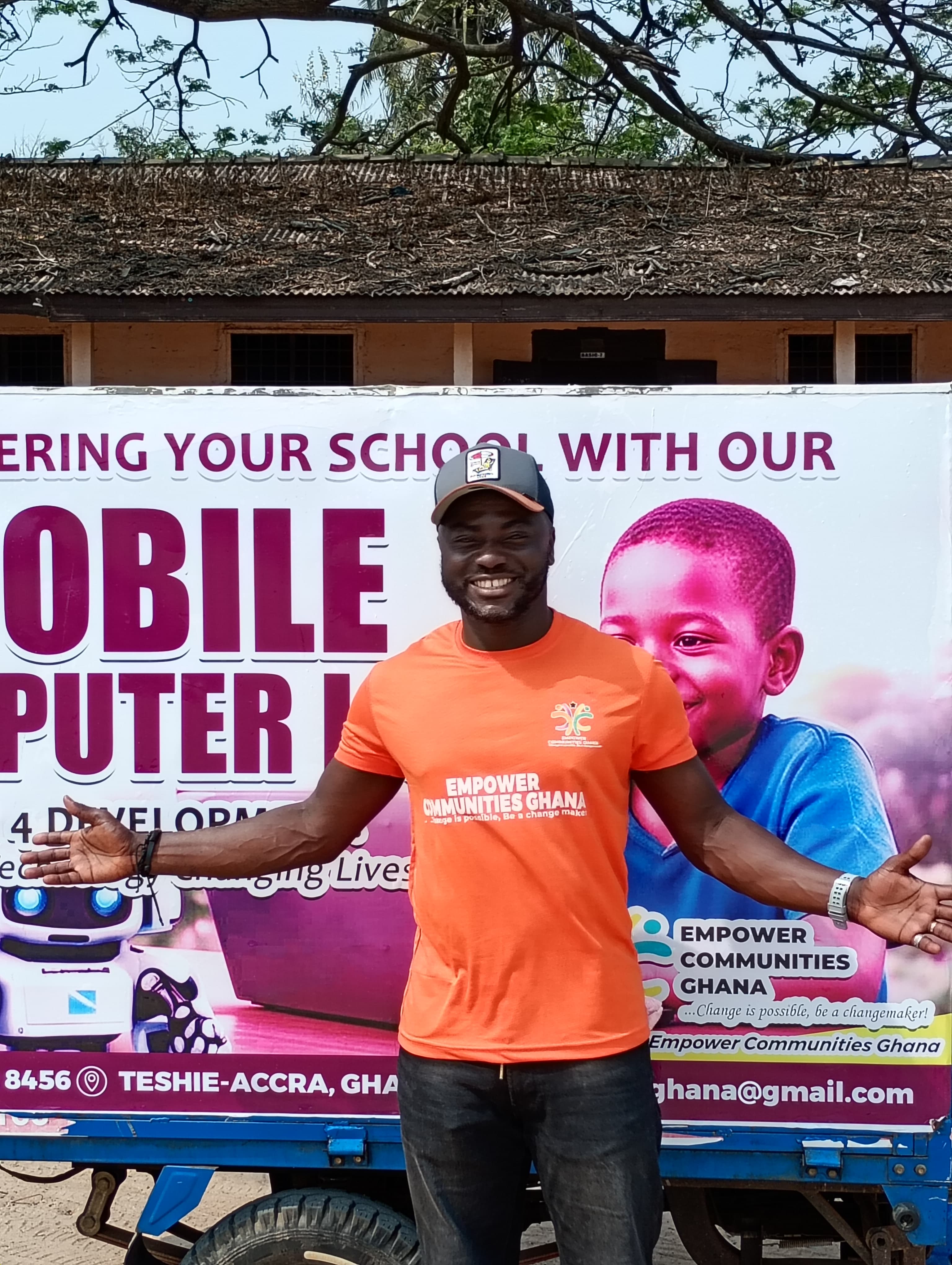 William Febiri with the branded Mobile Computer Lab tricycle